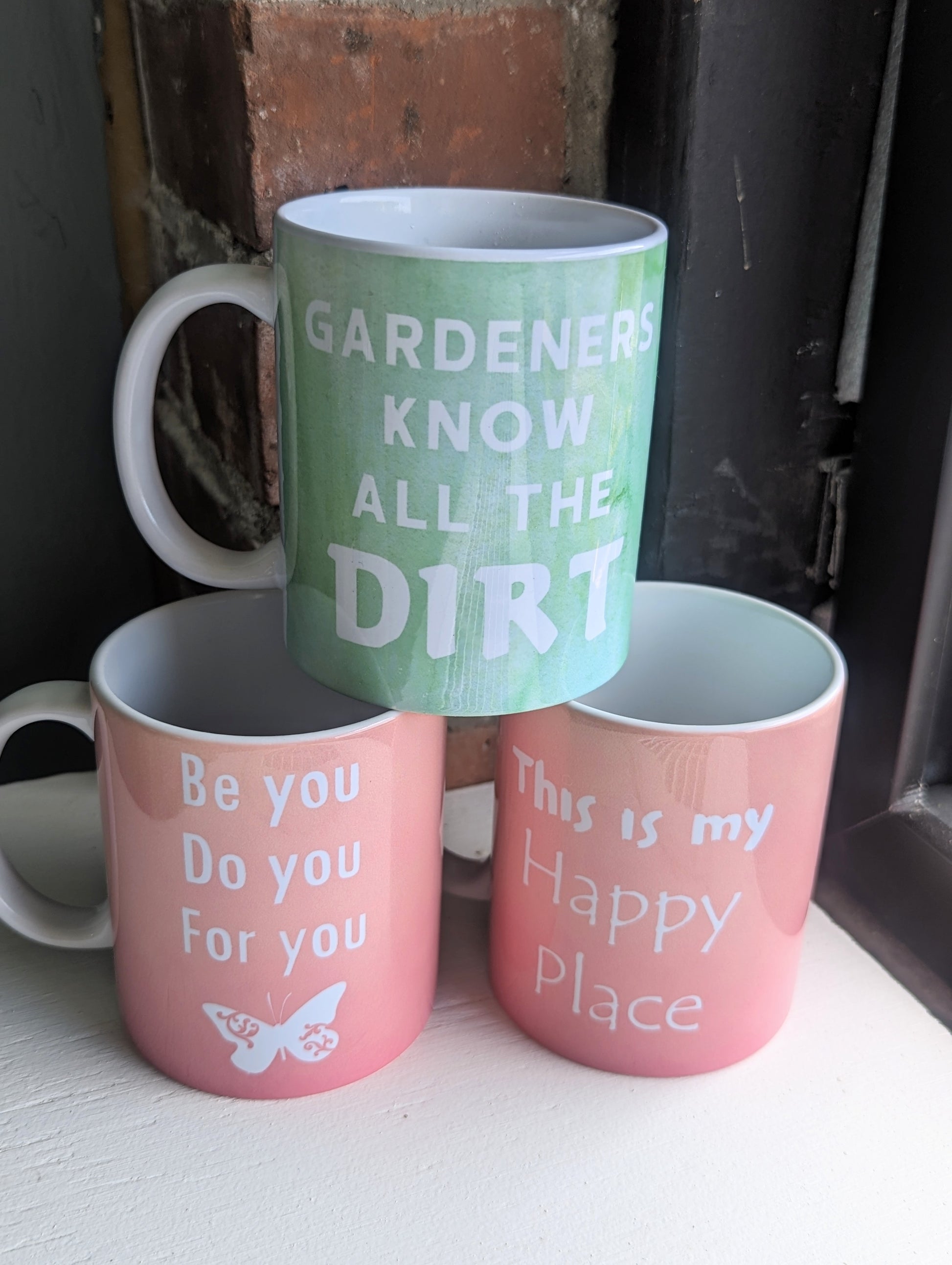 This is my happy place coffee mug stacked with other motivational coffee mugs