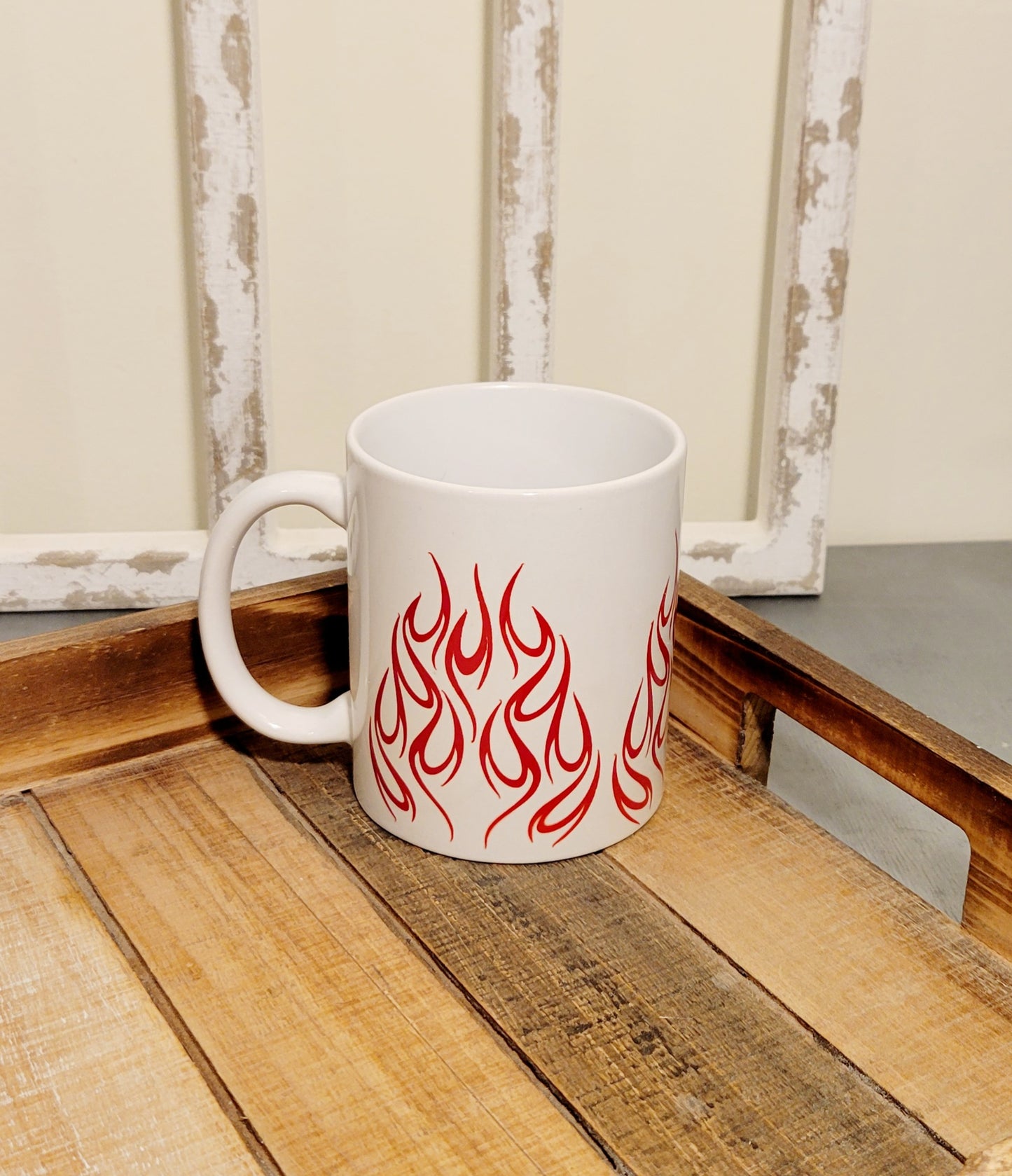 white 11 oz coffee mug with red flames on tray.