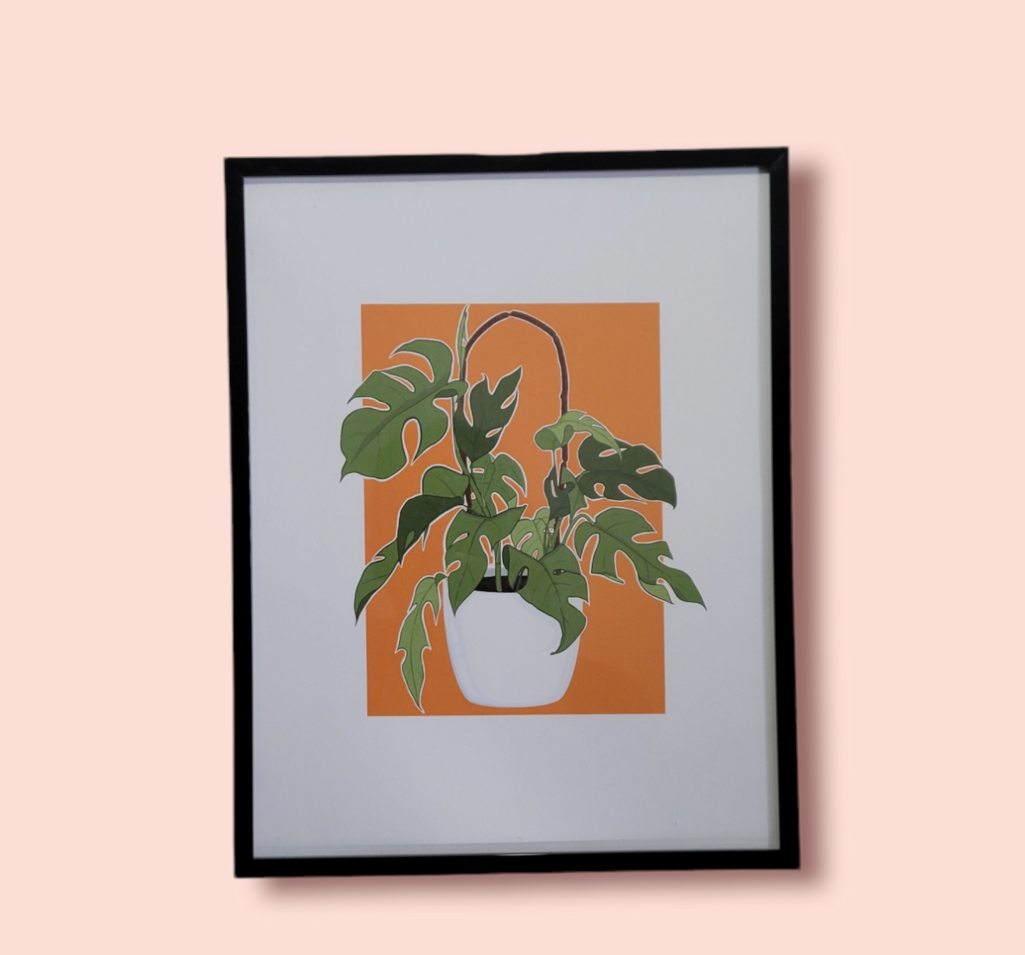 orange background plant art print in black frame