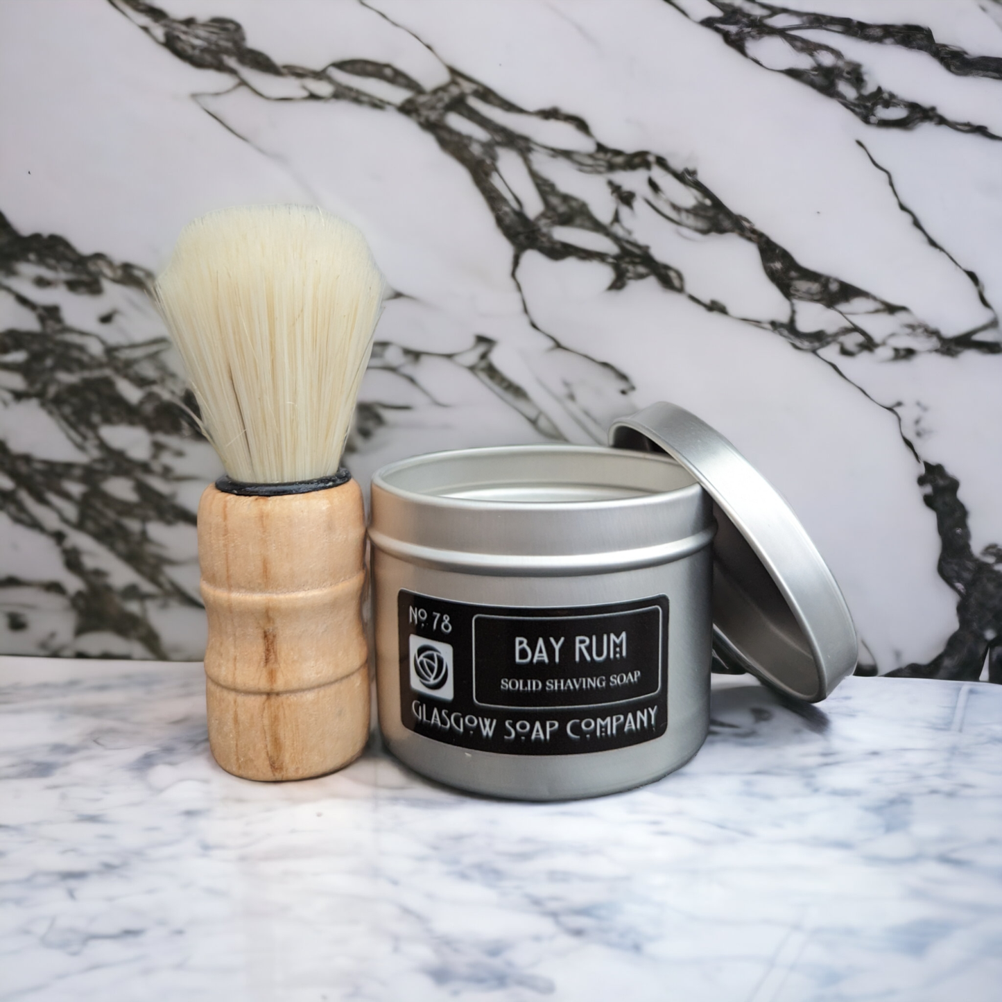 Tin can containing bay rum scented solid men's shaving soap.