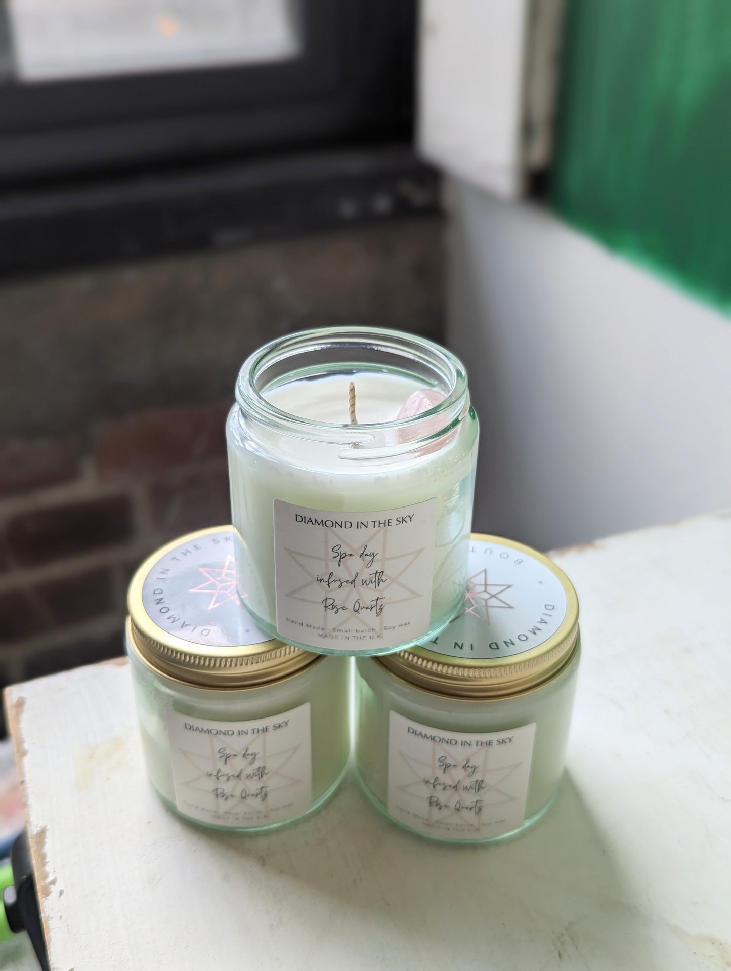 Spa day soy candle with rose quartz stone stacked in three