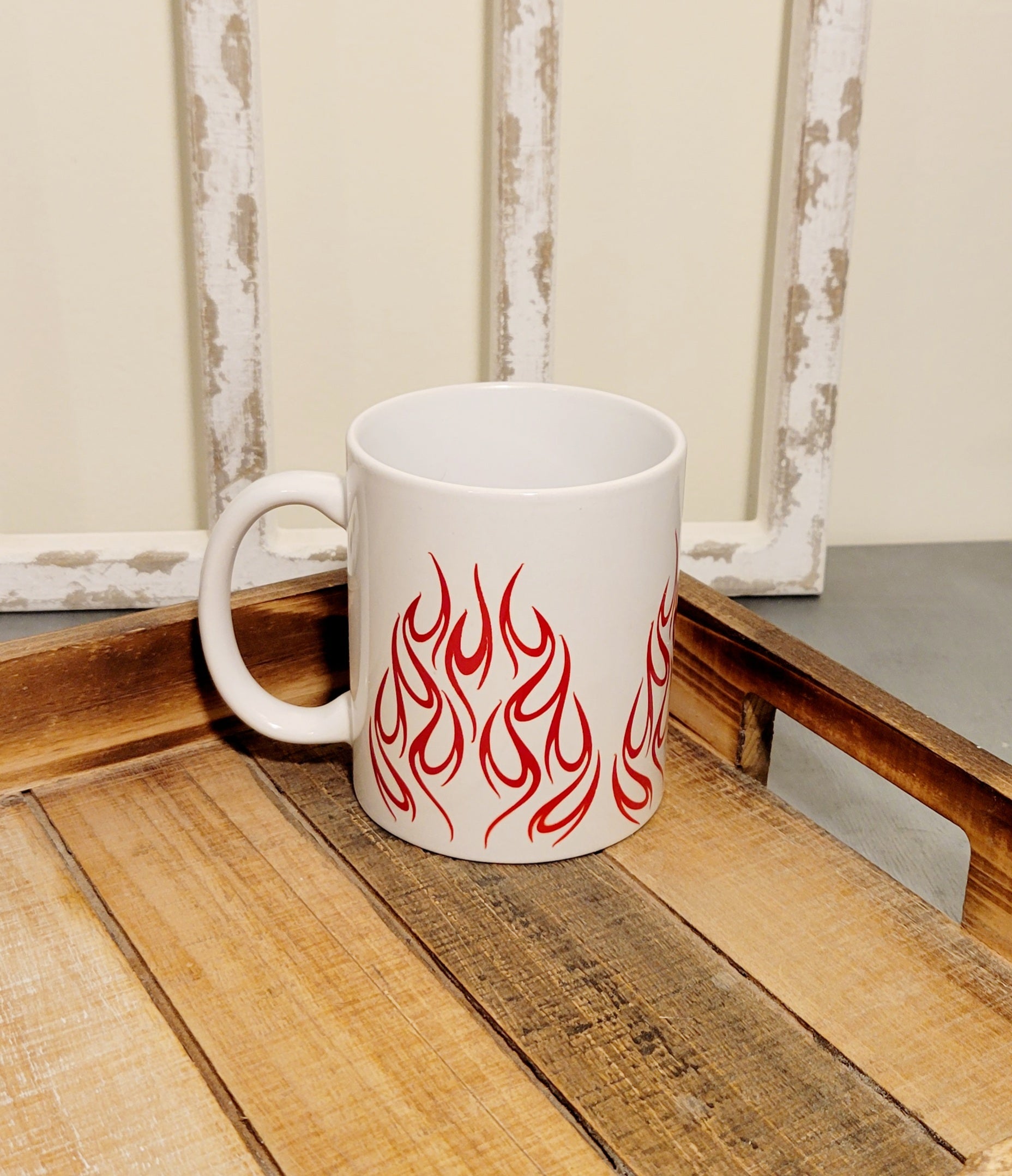 white 11 oz coffee mug with red flames on tray.