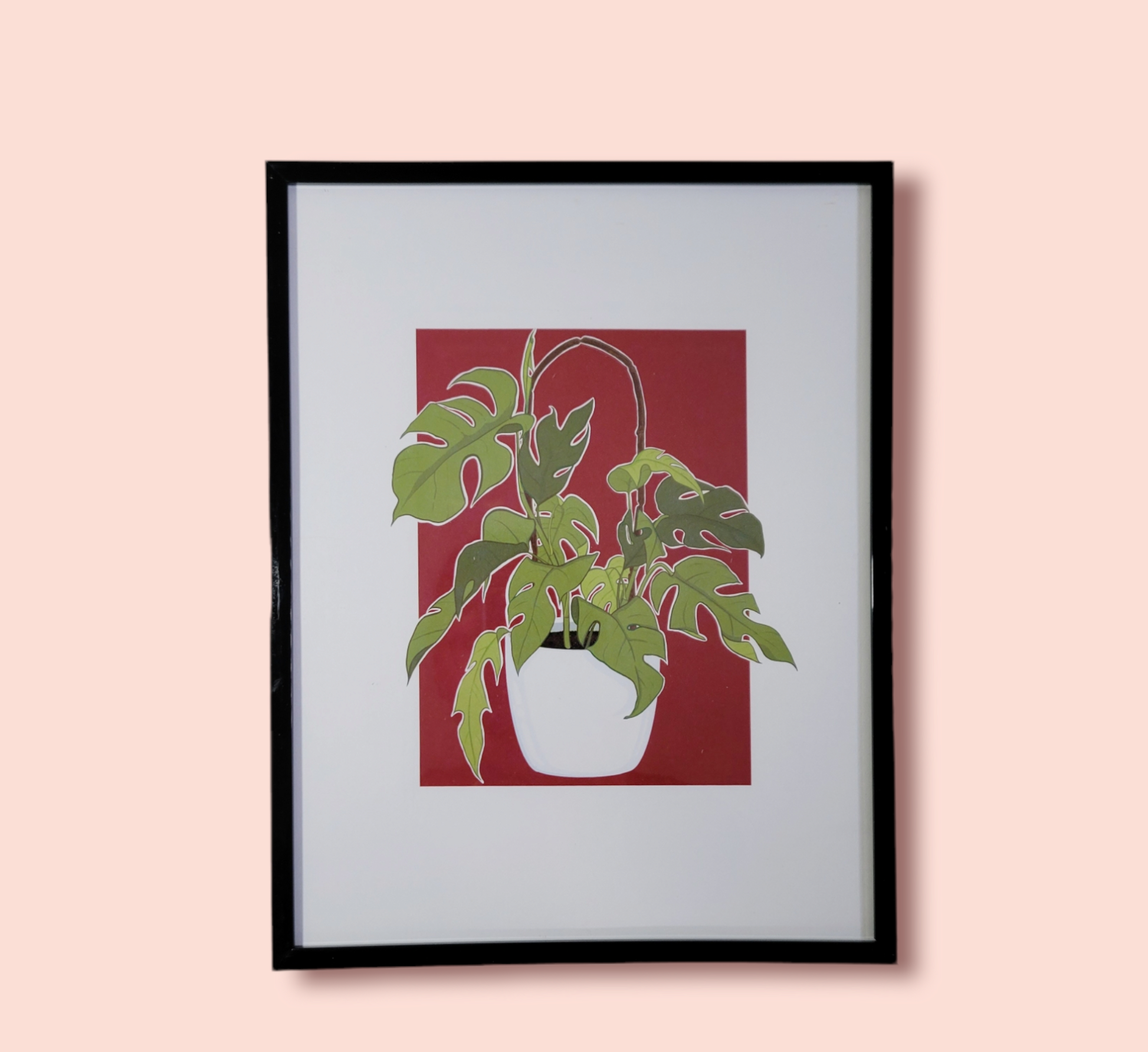 red background plant art print in black frame