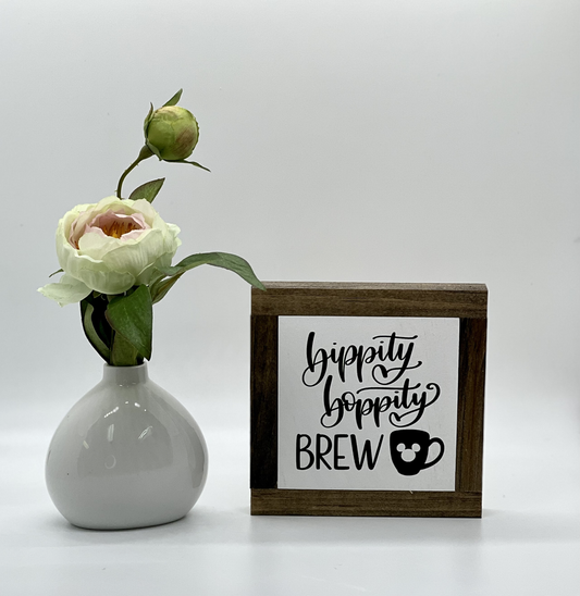 small wood sign with white background that says bippity boppity boo.