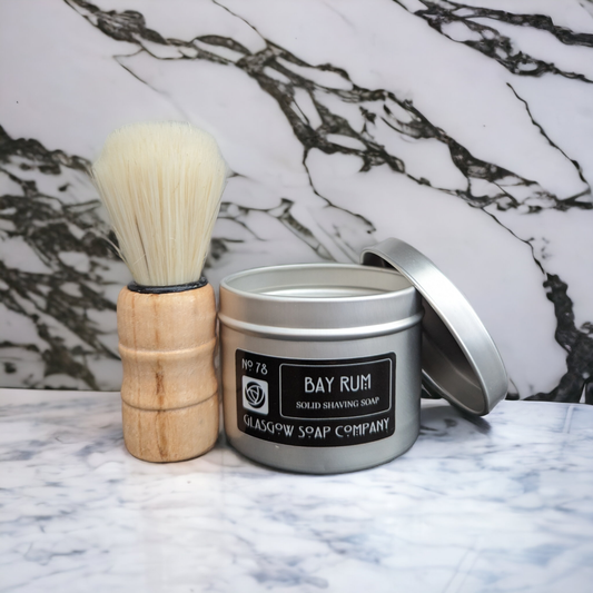 Tin can containing bay rum scented solid men's shaving soap. 